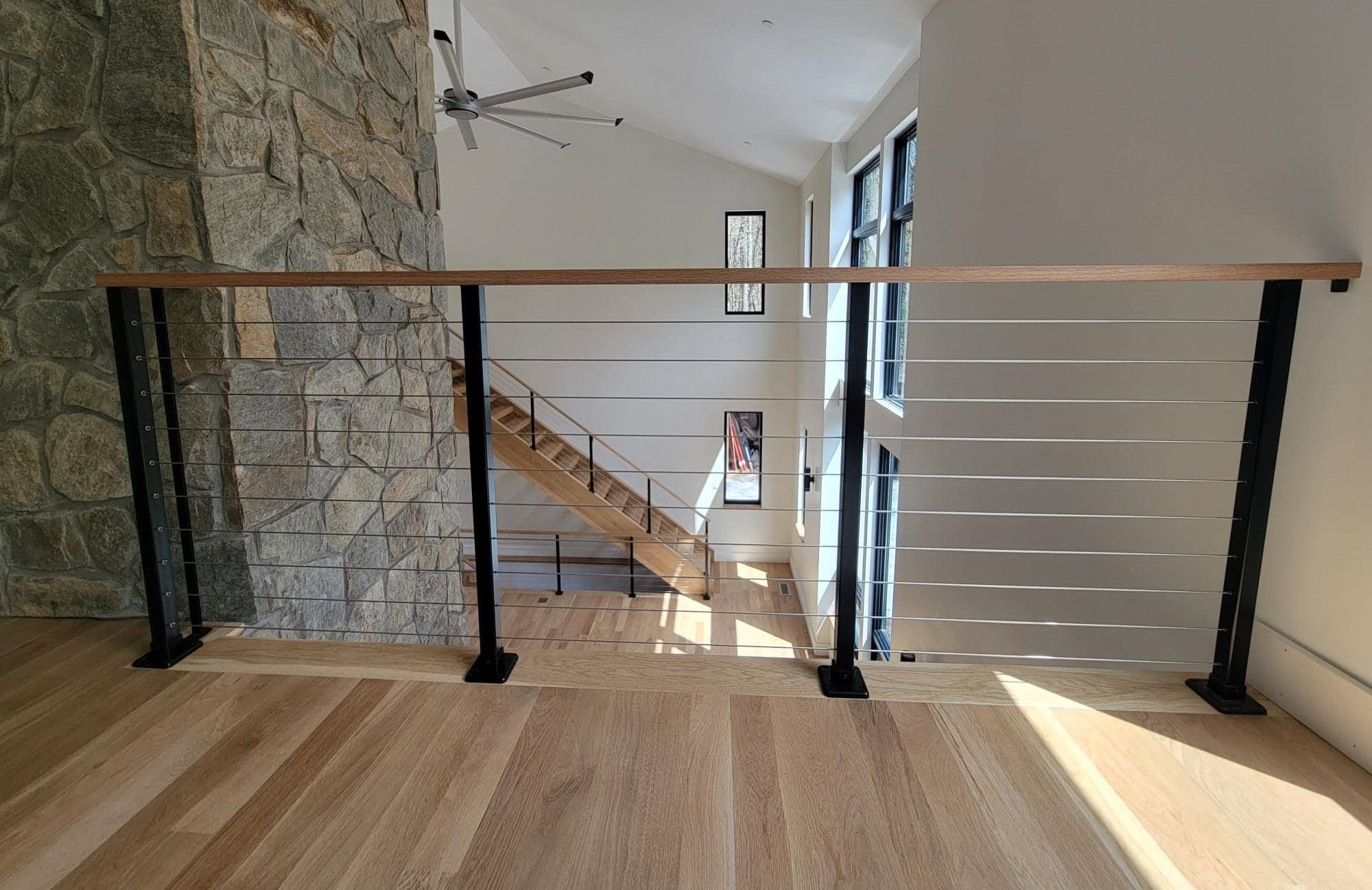 Powder coated steel cable railing with wood handrail