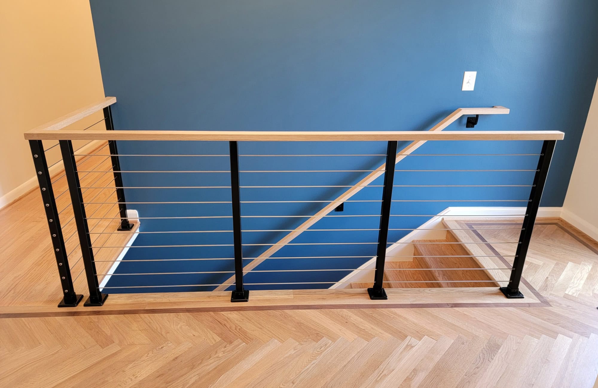 Powder coated steel cable railing with wood handrail cap